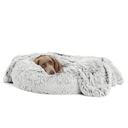 Dog lying on a fluffy gray pet bed against a white background